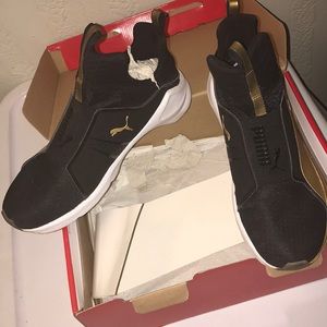 Black and Gold Puma sneakers
